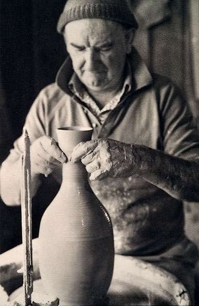 Charles Wilton, Potter, throwing a pot on wheel